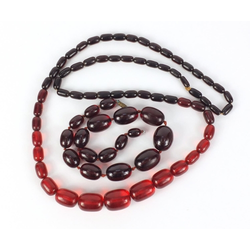 781 - Two cherry amber coloured bead necklaces, the largest 90cm in length, 147.0g