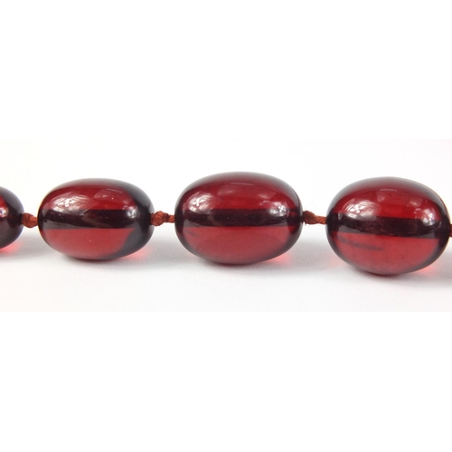 781 - Two cherry amber coloured bead necklaces, the largest 90cm in length, 147.0g