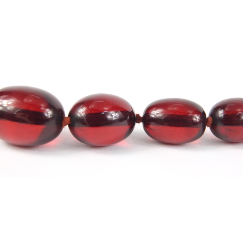 781 - Two cherry amber coloured bead necklaces, the largest 90cm in length, 147.0g