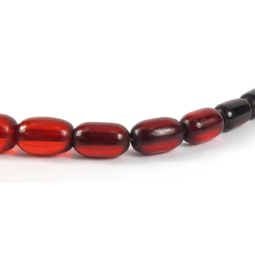 781 - Two cherry amber coloured bead necklaces, the largest 90cm in length, 147.0g