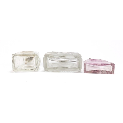 564 - Three Art Deco glass atomisers including one moulded with a nude female, the largest 14cm high