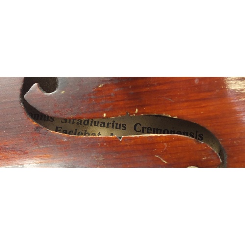 88 - Old wooden violin with bow and case, the violin bearing a Stradivarius paper label, the violin back ... 