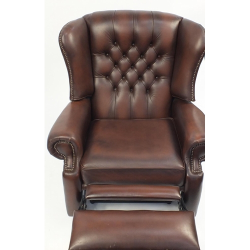 2049 - Brown leather wingback reclining armchair with button back, 99cm high