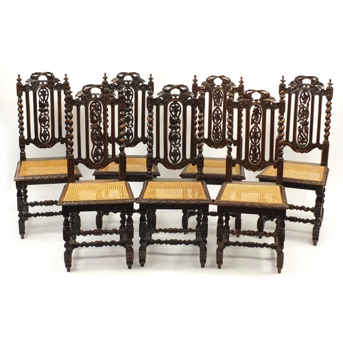 2036 - Harlequin set of seven carved oak barley twist chairs with cane seats, 107cm high