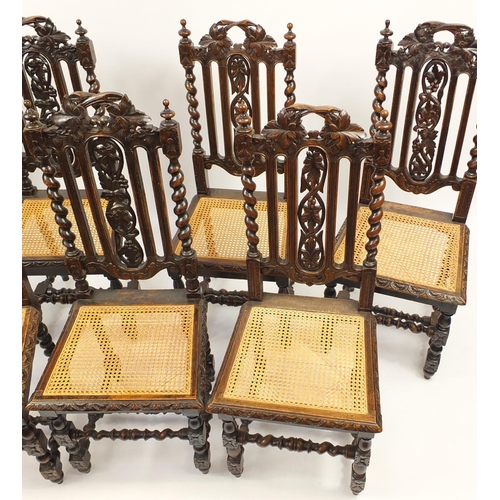 2036 - Harlequin set of seven carved oak barley twist chairs with cane seats, 107cm high