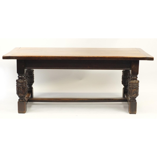 2008 - Oak refectory table with carved cup and cover bulbous legs united by a H stretcher, 73cm H x 184cm W... 