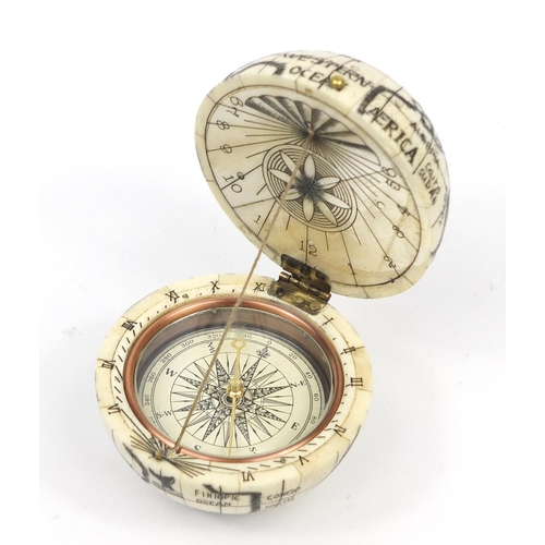 2458 - Sailor's style carved bone pocket globe and compass, 7cm in diameter