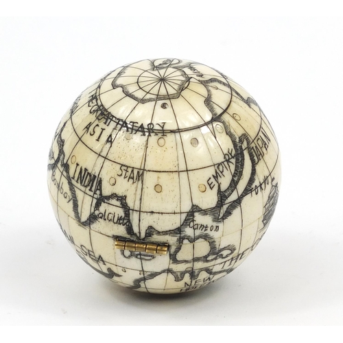 2458 - Sailor's style carved bone pocket globe and compass, 7cm in diameter