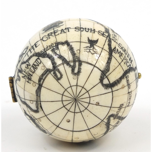 2458 - Sailor's style carved bone pocket globe and compass, 7cm in diameter