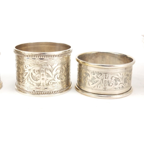 2504 - Four silver napkin rings and a cut glass claret jug with silver plated mounts, the largest 23cm high