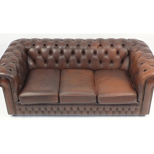 2011 - Brown leather three seater Chesterfield settee with buton back, 186cm wide