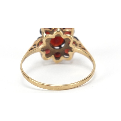 2556 - 9ct gold garnet flower head ring, size P, 1.9g