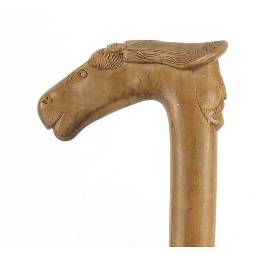 95 - Continental walking stick with carved Cypriot head and horse head handle, 89cm in length