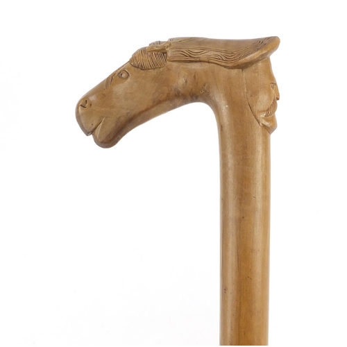 95 - Continental walking stick with carved Cypriot head and horse head handle, 89cm in length