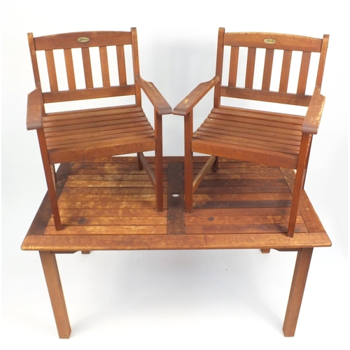 39 - Rectangular teak garden table and two chairs, the table 76cm H x 150cm W x 90cm D