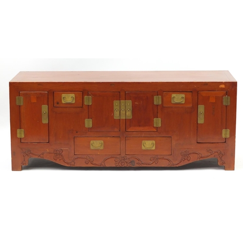 81 - Chinese stained wood side cabinet, fitted with an arrangement of cupboards and drawers with brass ha... 