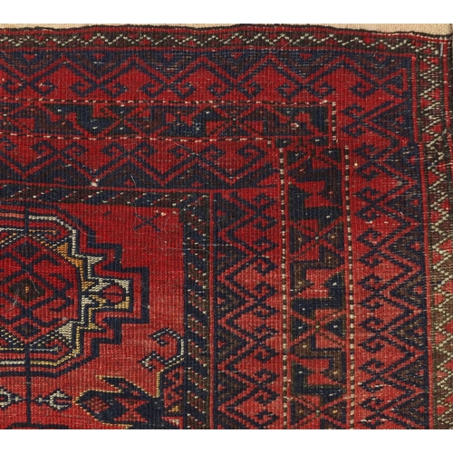 51 - Rectangular Oranda rug having an all over geometric design onto a red ground, 175cm x 96cm