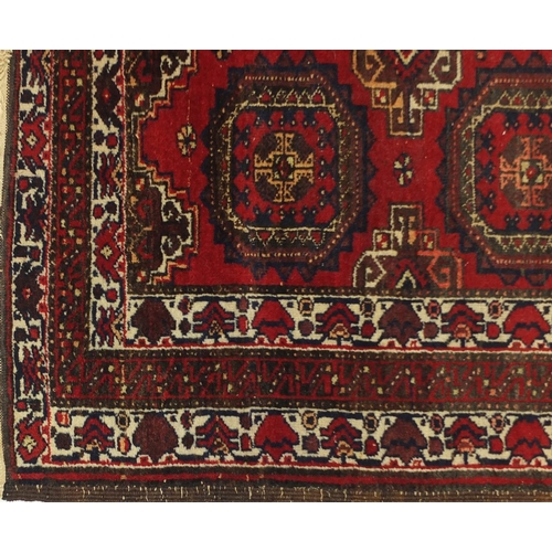 4 - Rectangular Oranda rug, having an all over geometric design onto a red ground, 175cm x 90cm