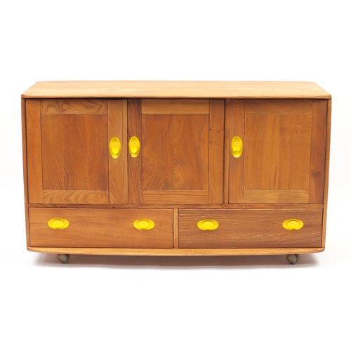 76 - Ercol light elm Windsor sideboard with three cupboard doors above two draws, 76cm H x 130cm W x 50cm... 