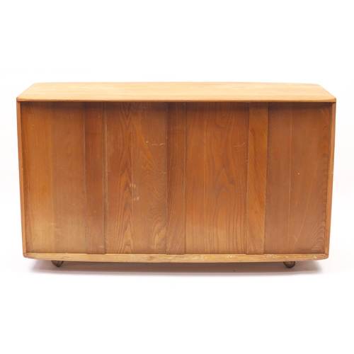 76 - Ercol light elm Windsor sideboard with three cupboard doors above two draws, 76cm H x 130cm W x 50cm... 