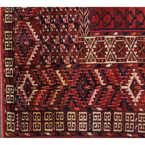 2076 - Turkman rug with all over blue and red geometric design, 140cm x 130cm