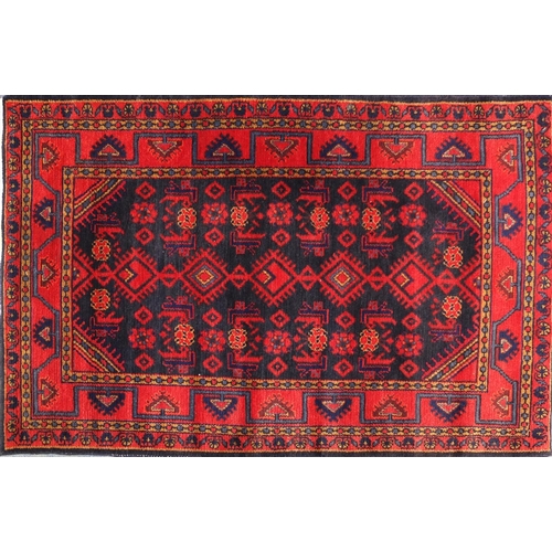 2067 - Rectangular Persian blue and red ground rug having a geometric design, 175cm x 115cm