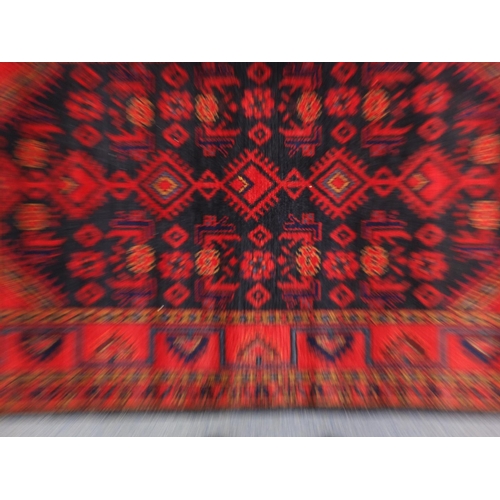 2067 - Rectangular Persian blue and red ground rug having a geometric design, 175cm x 115cm