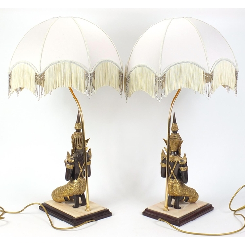 2063 - Pair of gilt bronze Thai buddha design table lamps with shades, overall 80cm high