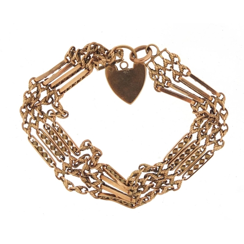 2520 - 9ct gold four row gate bracelet with love heart shaped padlock, 19.8g
