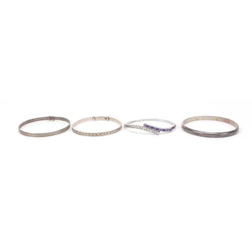 2572 - Four silver bangles, one set with colourful stones, 70.4g