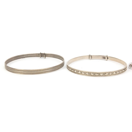 2572 - Four silver bangles, one set with colourful stones, 70.4g