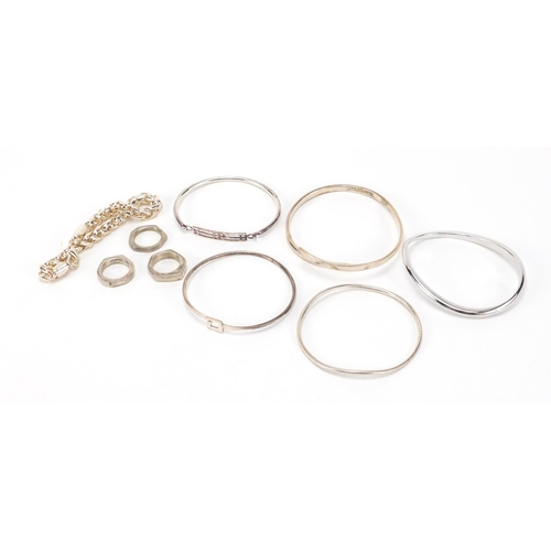 2621 - Group of silver and white metal bracelets and rings, 140.0g