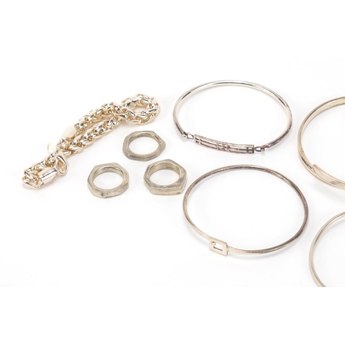 2621 - Group of silver and white metal bracelets and rings, 140.0g