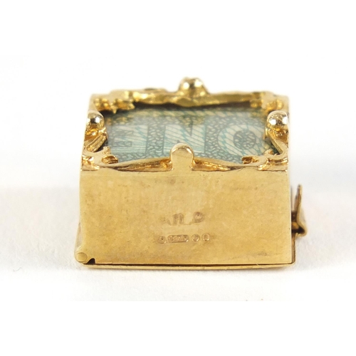 2612 - 9ct gold emergency one pound note charm, 1.5cm in length, 3.3g