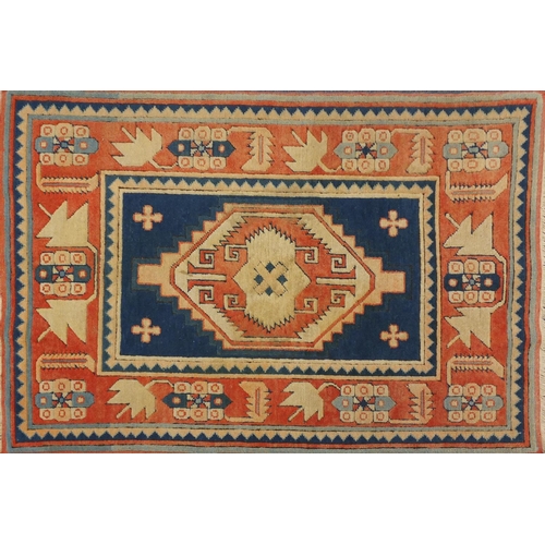 19 - Blue and salmon ground rug, having an all over geometric design, 175cm x 122cm