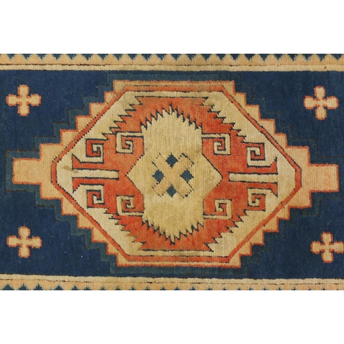 19 - Blue and salmon ground rug, having an all over geometric design, 175cm x 122cm