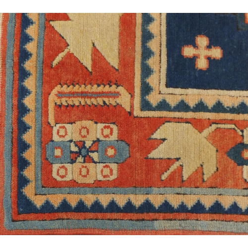 19 - Blue and salmon ground rug, having an all over geometric design, 175cm x 122cm