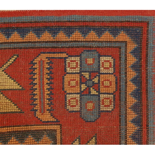 19 - Blue and salmon ground rug, having an all over geometric design, 175cm x 122cm