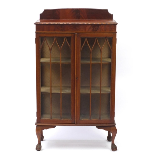 29 - Mahogany bow front display cabinet with a pair of glazed doors enclosing two shelves, raised on ball... 