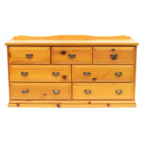 27 - Pine seven drawer chest, 79cm H x 148cm W x 41cm D