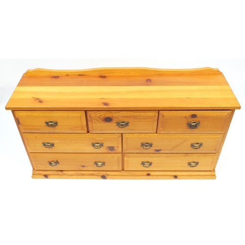 27 - Pine seven drawer chest, 79cm H x 148cm W x 41cm D