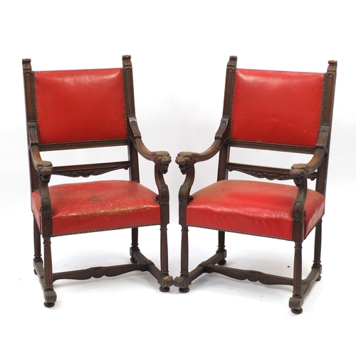 6 - Pair of oak framed carver chairs with carved dragon head handles and red leather upholstery