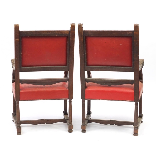 6 - Pair of oak framed carver chairs with carved dragon head handles and red leather upholstery