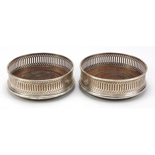 2503 - Pair of circular silver and oak wine coasters, hallmarked London, 1986, 12.5cm in diameter