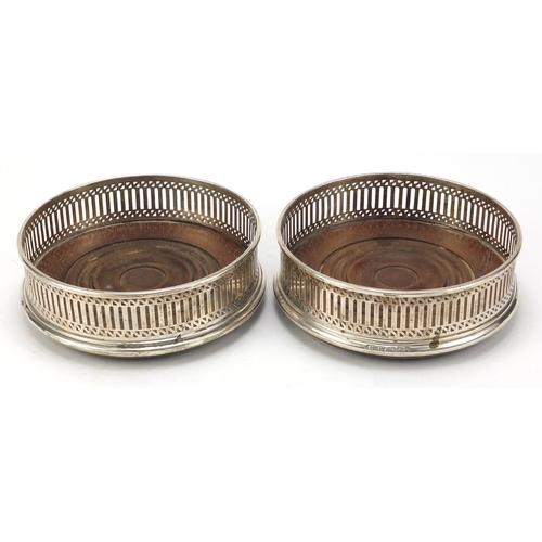 2503 - Pair of circular silver and oak wine coasters, hallmarked London, 1986, 12.5cm in diameter