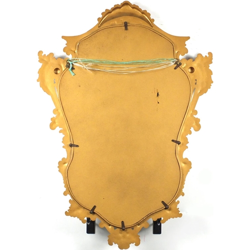 24 - Gilt framed cartouche shaped mirror, 74cm x 54cm