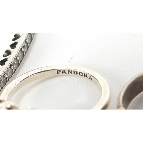 2604 - Pandora silver cubic zirconia bangle and three rings, 2.4g