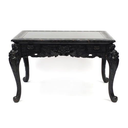 2018 - Ebonised carved oak centre table fitted with two draws, the top carved with Greek key and raised on ... 