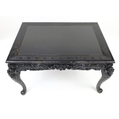 2018 - Ebonised carved oak centre table fitted with two draws, the top carved with Greek key and raised on ... 