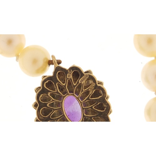 2519 - Single string pearl necklace with 9ct gold amethyst clasp, 36cm in length, 29.7g
